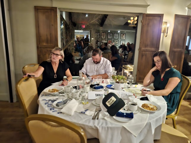 2024 Elimination Draw Attendees sitting around a table