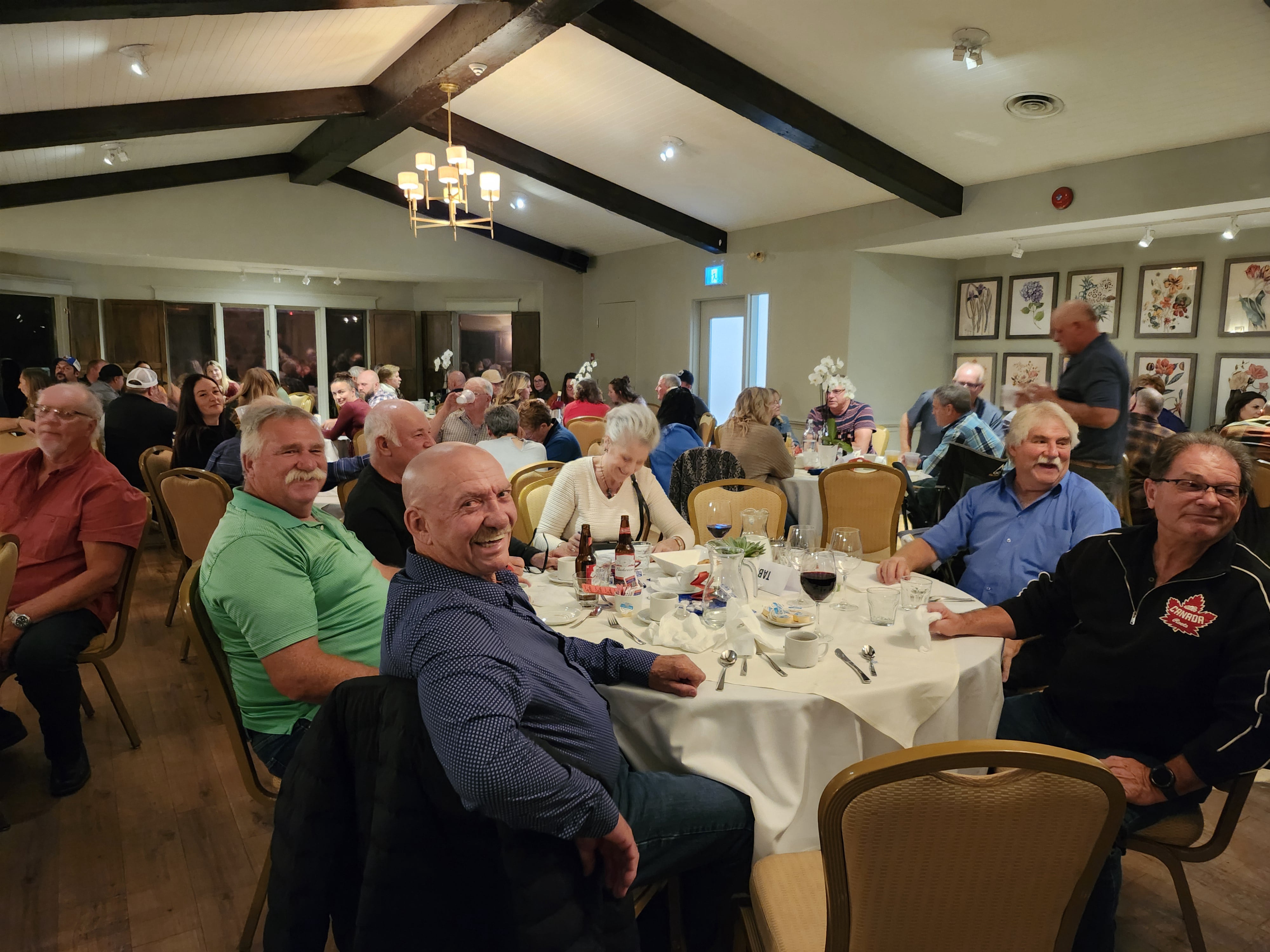 2024 Elimination Draw Attendees sitting around a table