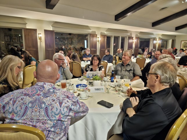 2024 Elimination Draw Attendees sitting around a table