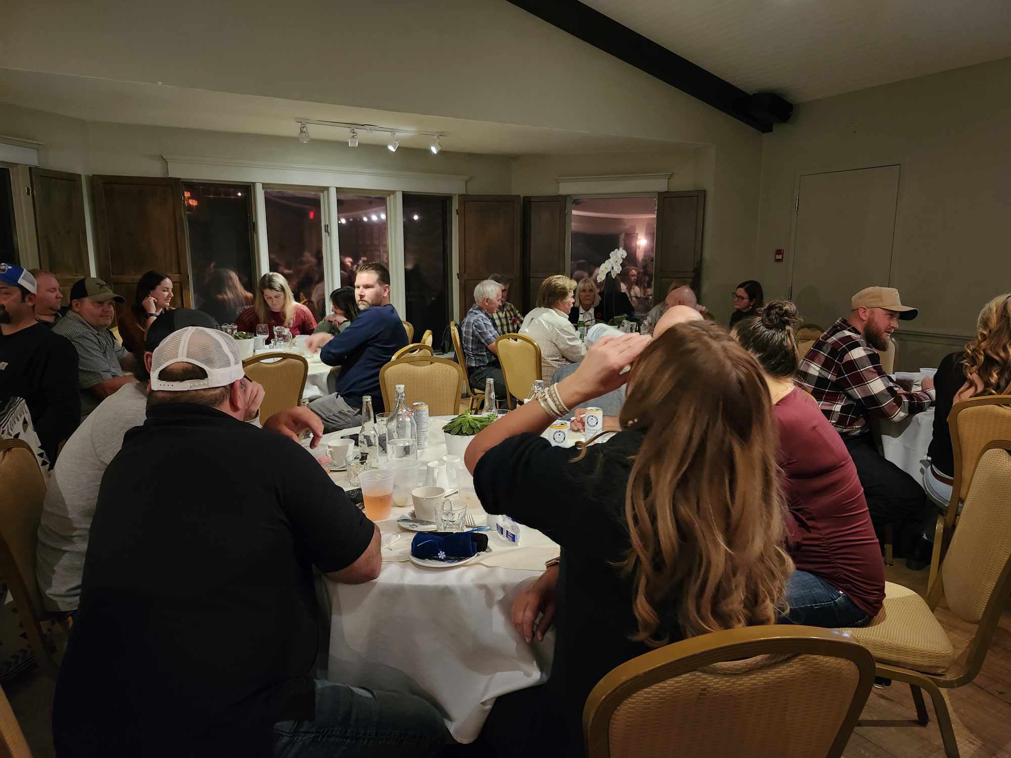 2024 Elimination Draw Attendees sitting around a table